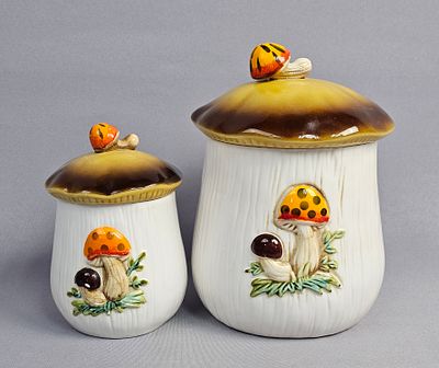 Pair of Vintage Merry Mushroom Ceramic Canisters. A pair of graduated, lidded storage canisters 