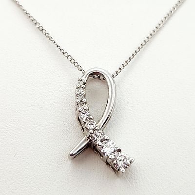 10K White Gold Necklace 2.6 Grams. This necklace features a stylized ribbon or loop design 