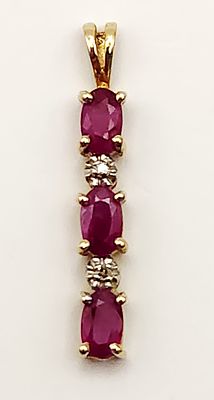 10K Gold Ruby Pendant 1.0 Gram. This vertical drop pendant is constructed in 10 karat yellow 