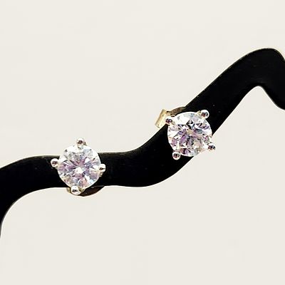 14K White Gold CZ Earrings 1 Gram. A pair of white metal stud earrings, each featuring a round 