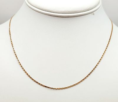 18K Link Necklace 2.2 Grams. An 18 karat yellow gold scroll-link chain necklace featuring a 