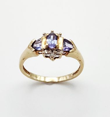 10K Gold Tanzanite Ring 1.9 Grams. This yellow gold ring features a central three-stone design 