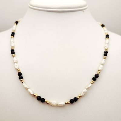 14K Pearl Necklace. This necklace is composed of a single strand of irregular white baroque 