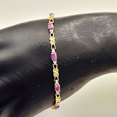 10K Ruby Bracelet 4.7 Grams. A 10K yellow gold link bracelet featuring oval-cut rubies and cz 