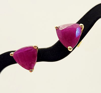 10K Gold Ruby Earrings 1.3 Grams. A pair of 10-karat yellow gold stud earrings, each featuring a 