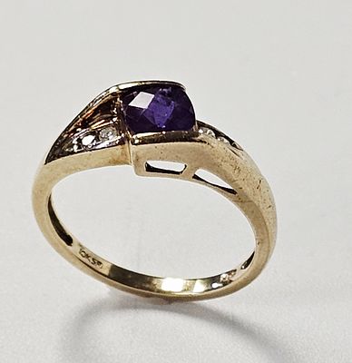 10K Purple Gemstone & Diamond Accents Ring. A 10 karat yellow gold fashion ring featuring an 