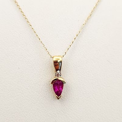 14K Gold Ruby Necklace 0.9 Grams. This necklace features a fine link 14 karat yellow gold chain 