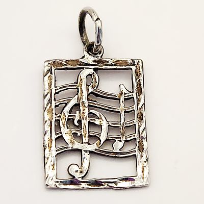 14K Treble Clef Pendant 1.7 Grams. This lot features a 14-karat white gold pendant designed with 