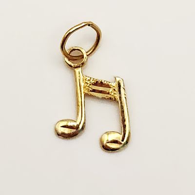 14K Musical Note Charm 0.4 Grams. A 14 karat yellow gold charm designed as a beamed pair of 
