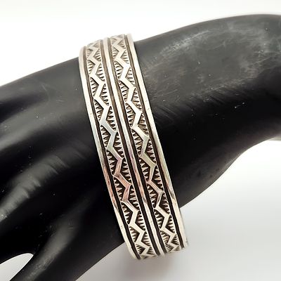 Sterling Navajo Cuff Bracelet 60.1 Grams. This sterling cuff bracelet features a deeply stamped 