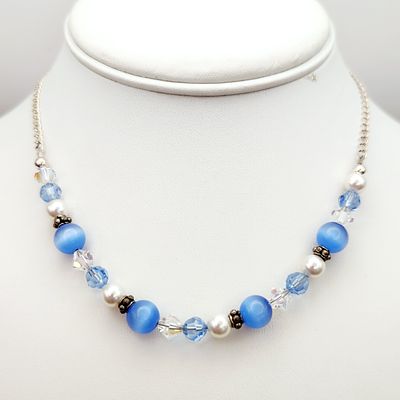 Sterling Beaded Necklace 11.7 Grams. This beaded necklace is composed of light blue fiber optic 