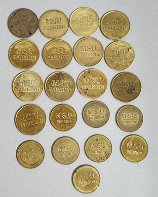 Michigan State University Parking Tokens. A collection of brass parking tokens attributed to 