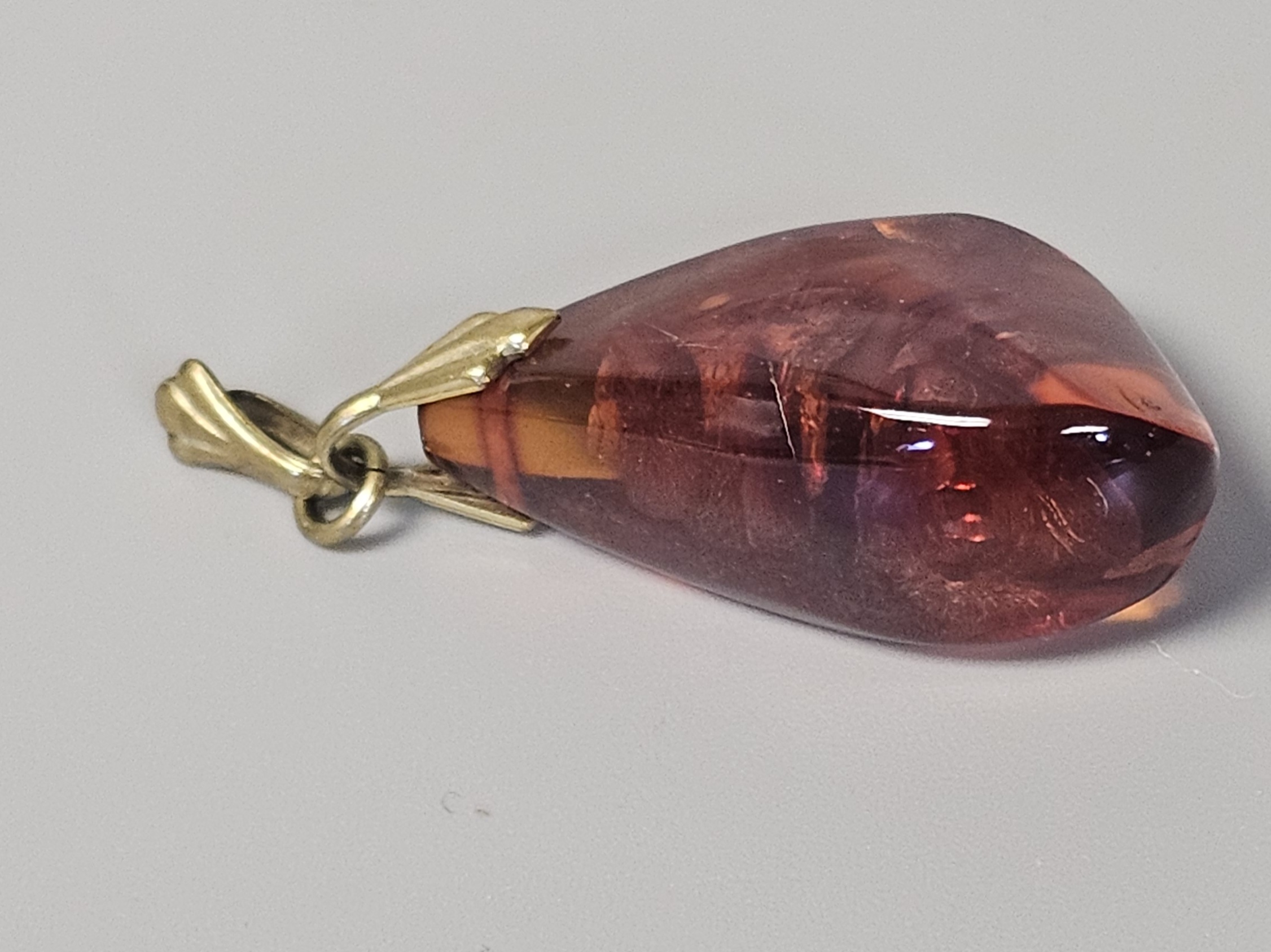 Two Translucent Cognac Amber Pendants