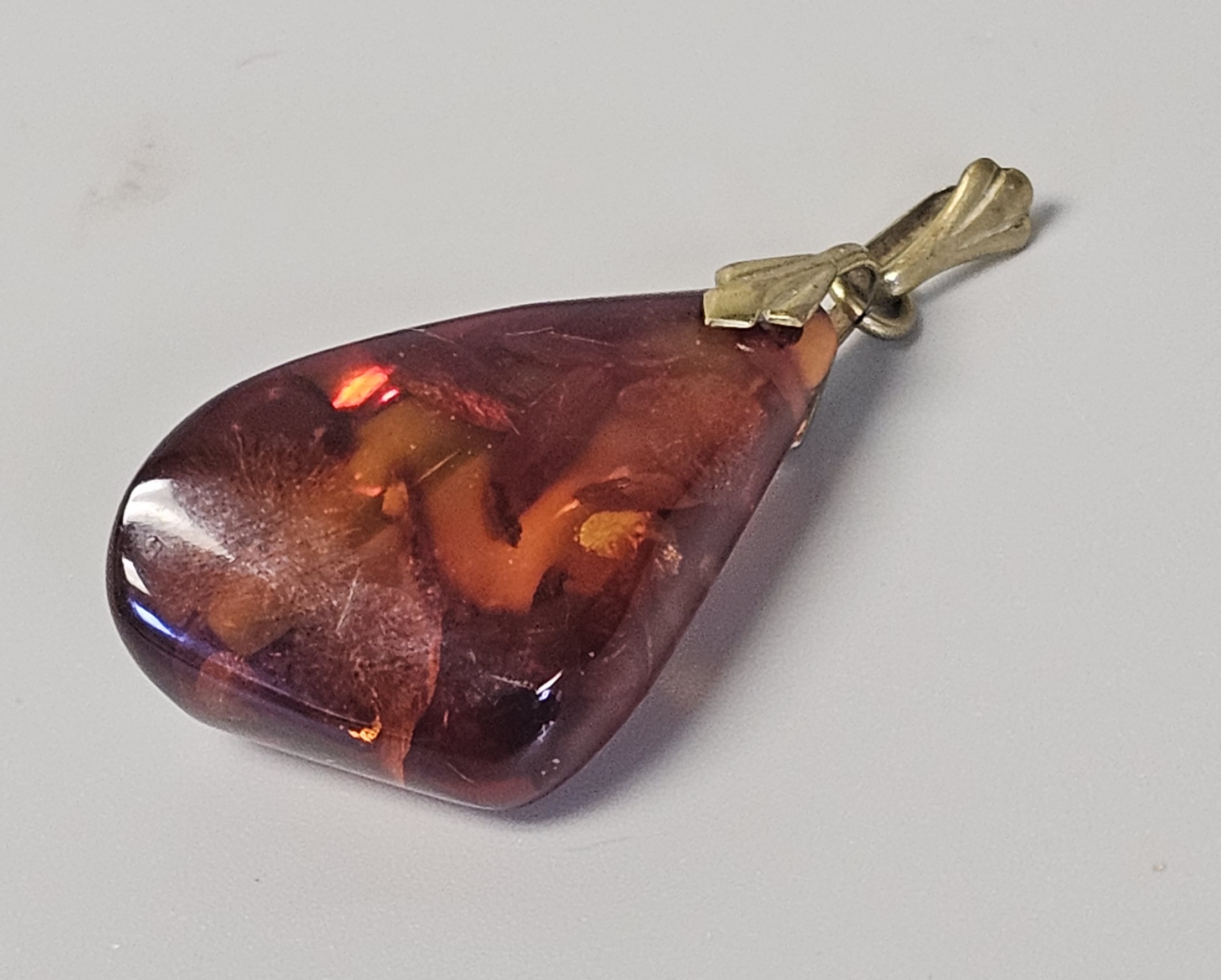 Two Translucent Cognac Amber Pendants