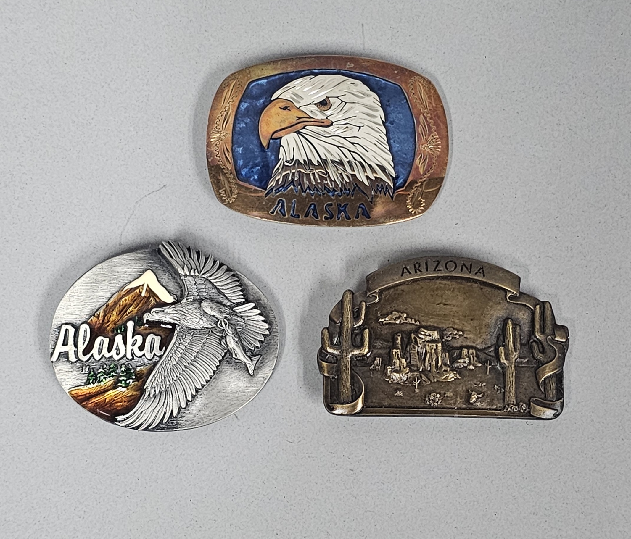 Trio of Souvenir Belt Buckles