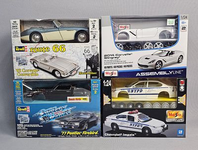 Assortment of Four Model Car Kits. An assortment of four unassembled model car kits by Revell 