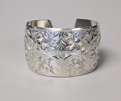 Sterling Engraved Floral Cuff 33.3 Grams. This wide Sterling cuff bracelet features elaborate 
