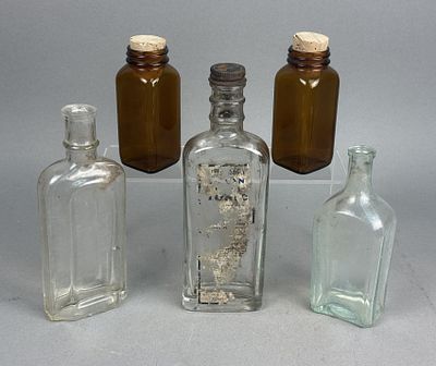 Assortment of Antique Glass Apothecary & Medicine Bottles. The group includes a clear glass 