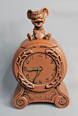 Ceramic Mouse Clock Cookie Jar. This novelty earthenware cookie jar is designed in the shape of 