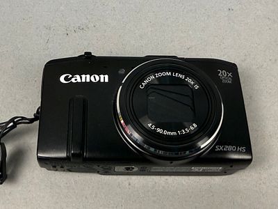Canon PowerShot SX280 HS Digital Camera. A black Canon PowerShot SX280 HS digital compact camera 