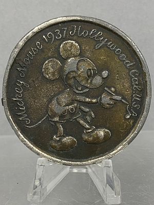 Mickey Mouse Vintage Belt Buckle. A circular brass-tone belt buckle featuring a raised relief of 