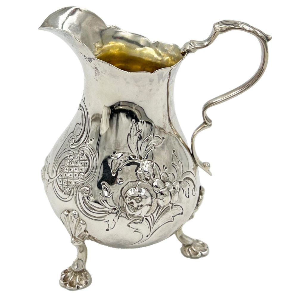 Lot 162: A VICTORIAN SILVER CREAM JUG WITH FLORAL DECORATION,...