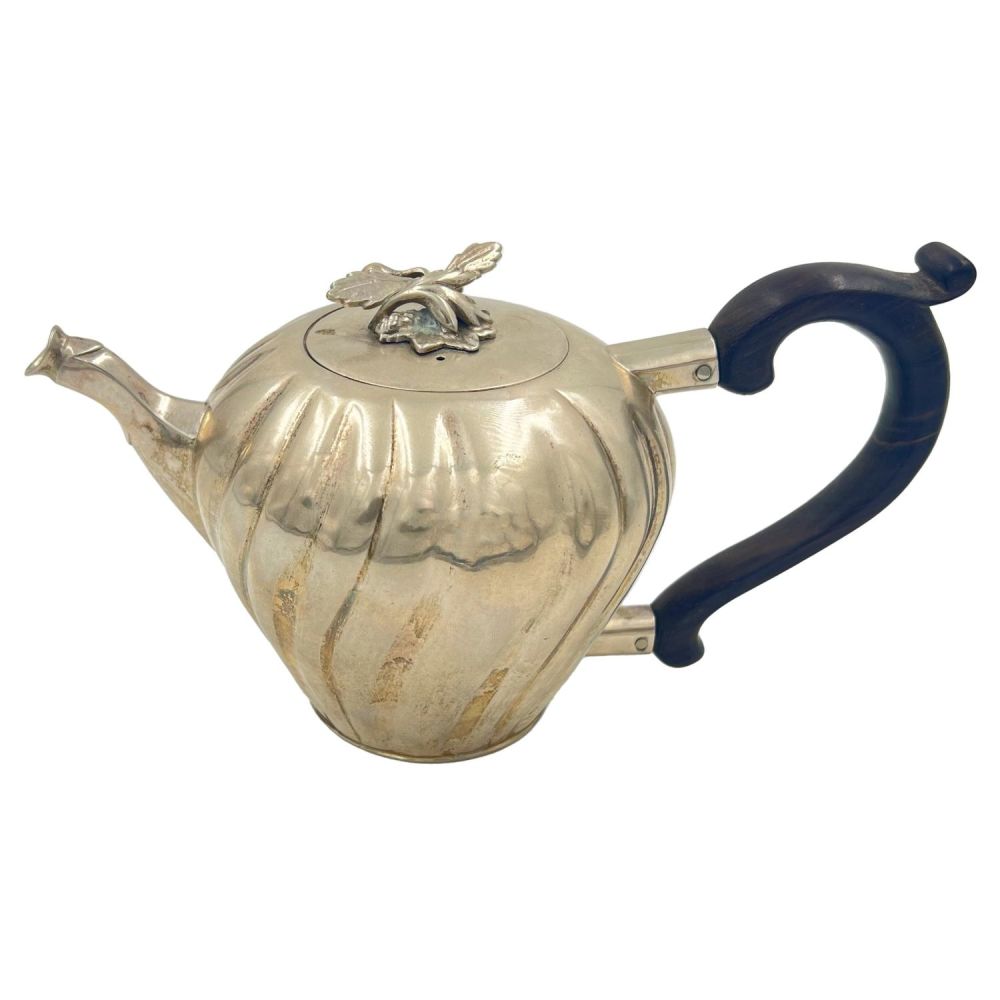 Lot 194: A CONTINENTAL SILVER TEAPOT WITH WRYTHEN PATTERN DECORATION