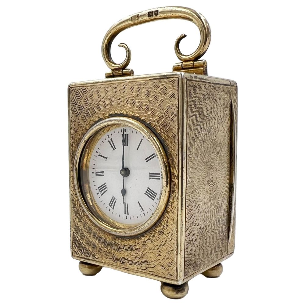 Lot 215: A SMALL SILVER CASED MANTEL/TRAVELLING CLOCK WITH CIRCULAR...
