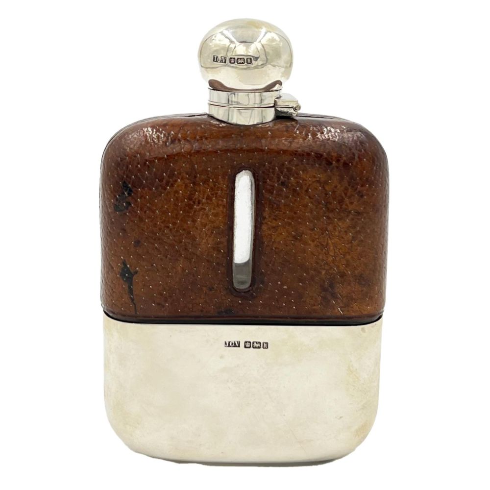 Lot 225: A SILVER TOPPED AND LEATHER CASED GLASS HIP...