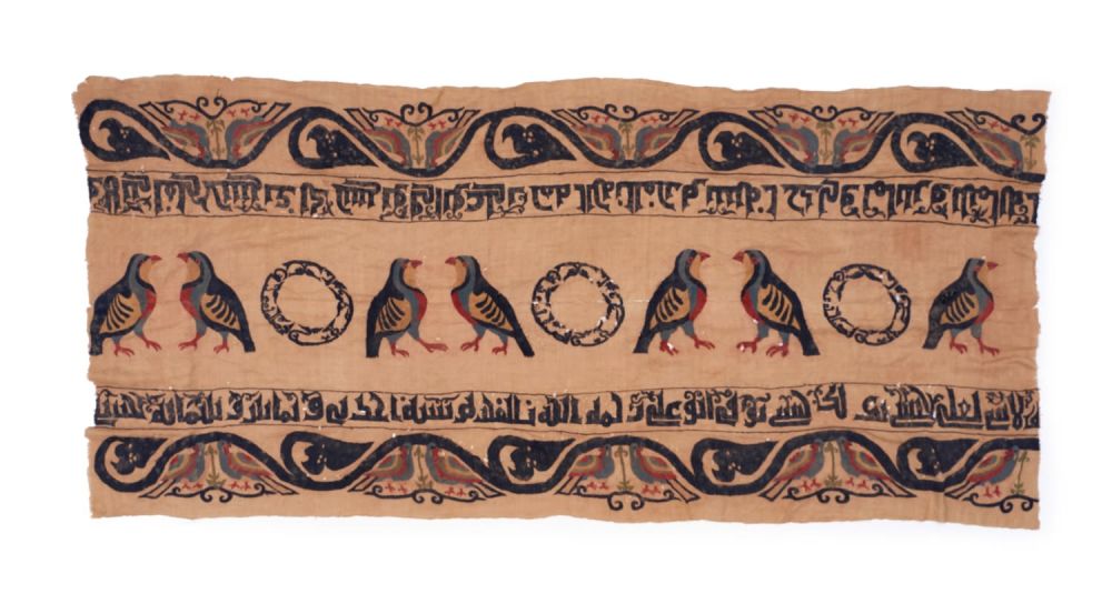 Lot 269: A KUFIC INSCRIBED TEXTILE WITH BIRDS, IN THE...