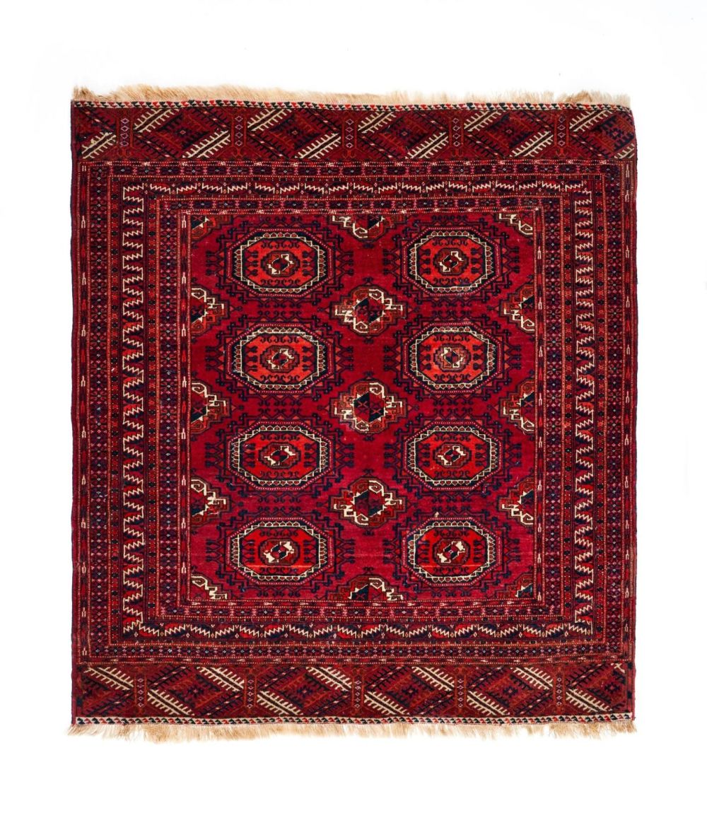 Lot 273: A RED HAND KNOTTED WOOL RUG FROM BOKHARA,...