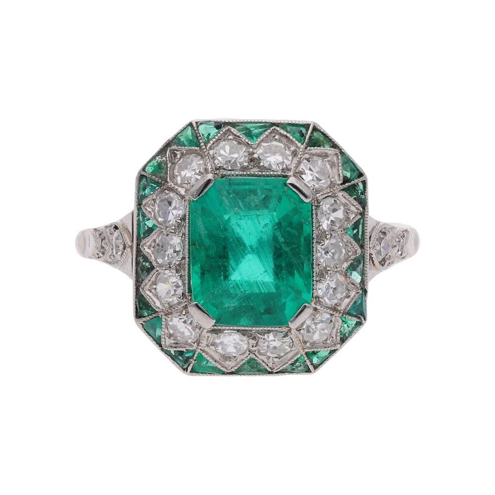 Lot 255: Art Deco Platinum Columbian Emerald and Diamond Cluster Ring.