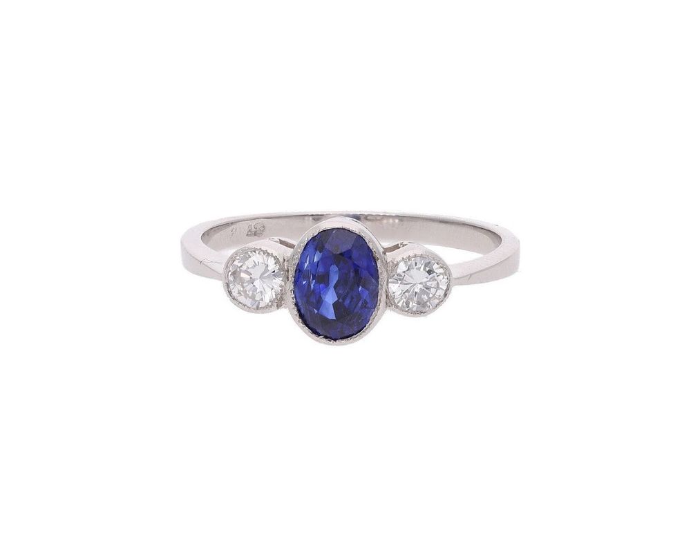 Lot 449: Platinum Blue Sapphire and Diamond Three Stone Ring.
