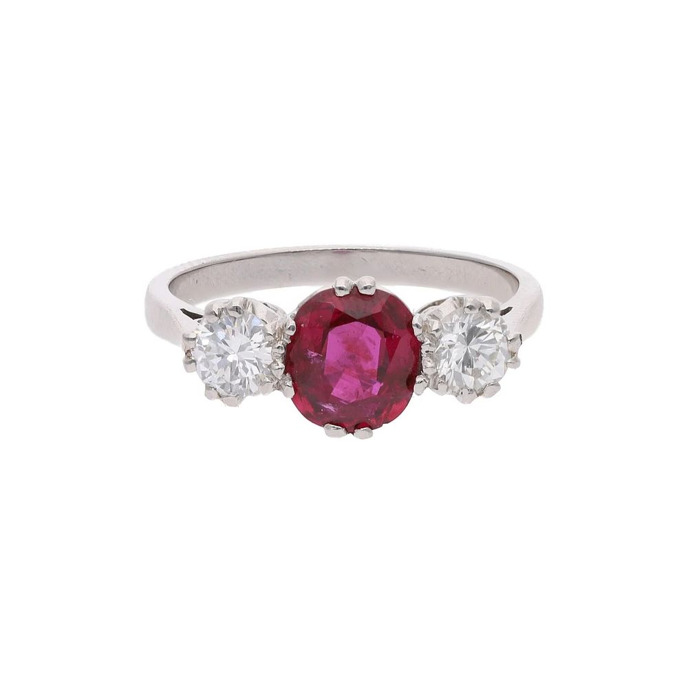 Lot 475: Platinum Ruby and Diamond Three Stone Ring.