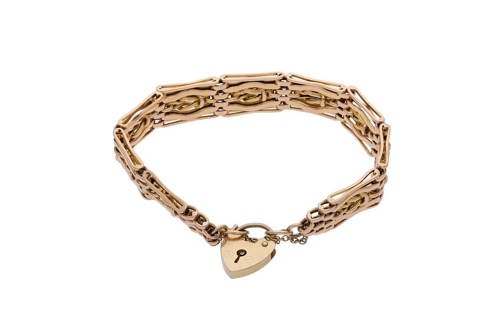 Lot 514: 9ct Gold and Padlock Gate Charm.