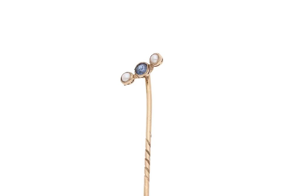 Lot 557: 9ct Gold Sapphire and Pearl Stick Pin.