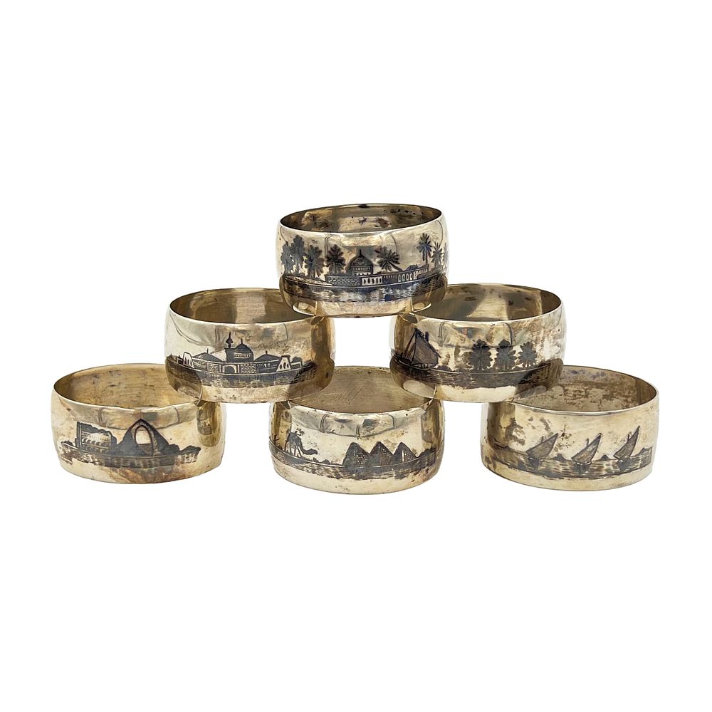 Lot 186: A SET OF SIX MID-20TH CENTURY IRAQI SILVER AND NIELLO NAPKIN RINGS
