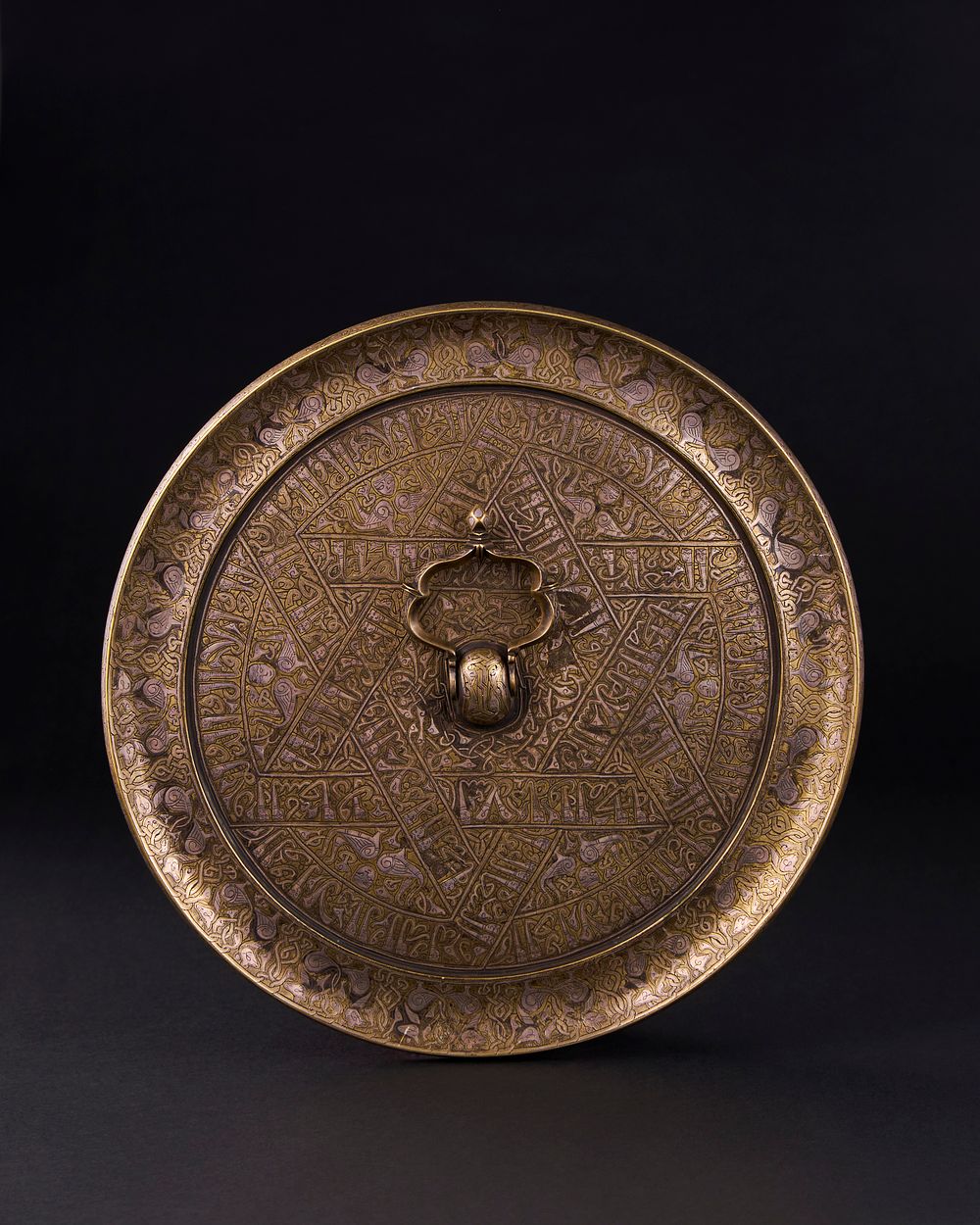 Lot 163: A CALLIGRAPHIC INSCRIBED SELJUK BRONZE CIRCULAR MIRROR, PERSIA, 12TH CENTURY