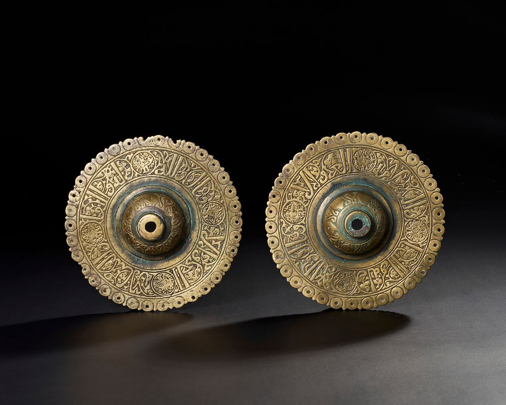 Lot 170: A PAIR OF 13TH CENTURY PERSIAN SELJUK BRONZE DOOR BOSSES WITH KUFIC CALLIGRAPHY