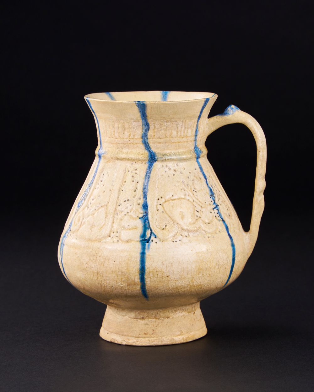 Lot 165: A KASHAN PIERCED AND INCISED BLUE AND WHITE POTTERY JUG, PERSIA, 12TH/ 13TH CENTURY