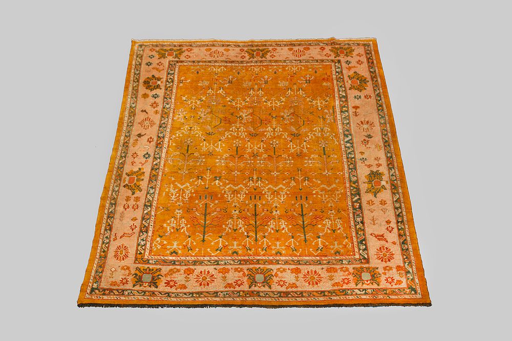 Lot 344: A LARGE WOOL USHAK CARPET, 315 X 287CM