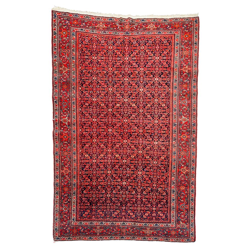 Lot 203: RED PERSIAN WOOL RUG, 20TH CENTURY