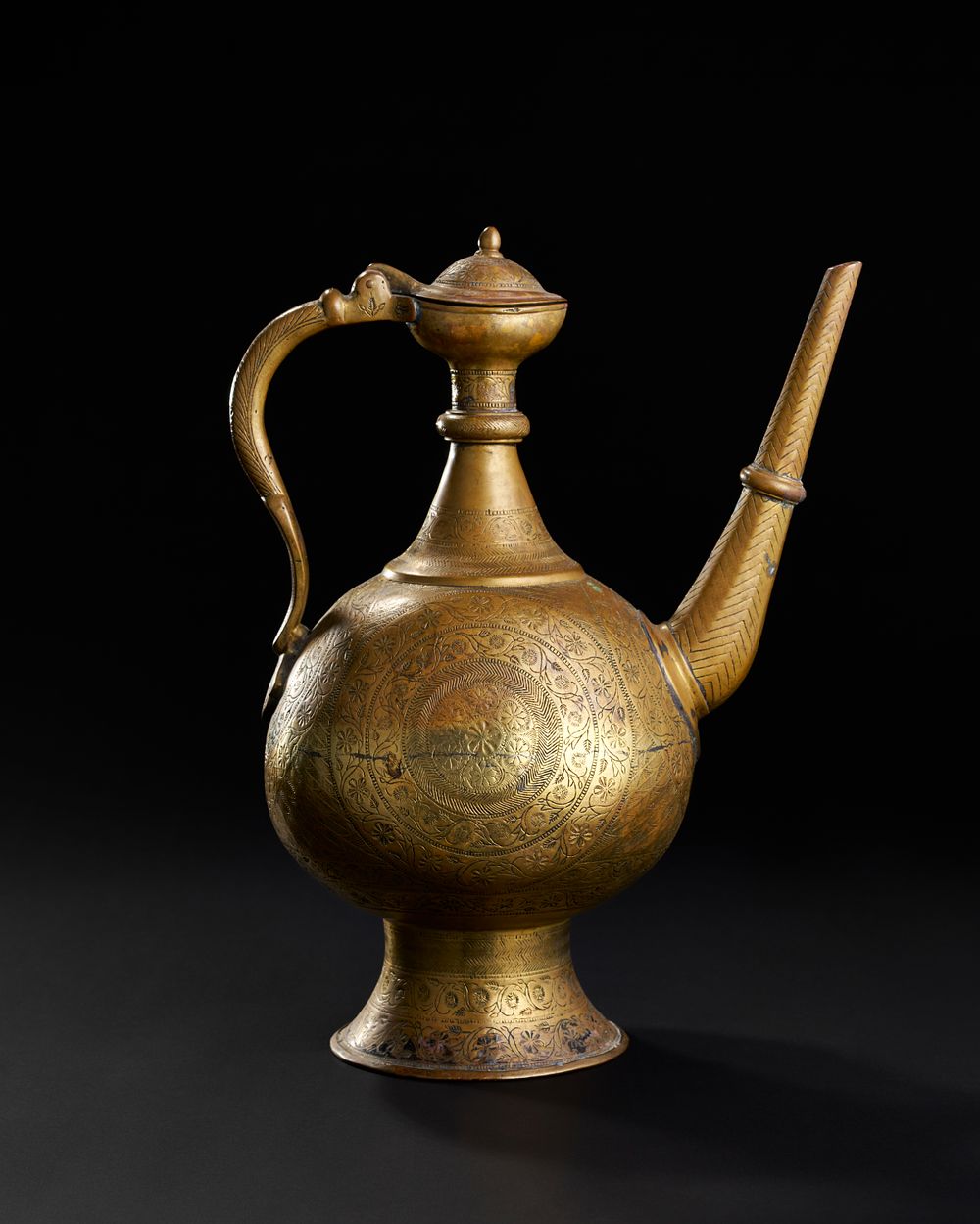Lot 232: A FINELY ENGRAVED MUGHAL BRASS EWER, NORTH INDIA, LAHORE, 18TH CENTURY
