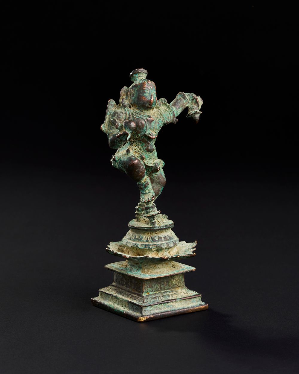 Lot 175: A 17TH CENTURY OR EARLIER SOUTH INDIAN BRONZE FIGURE OF DANCING KRISHNA