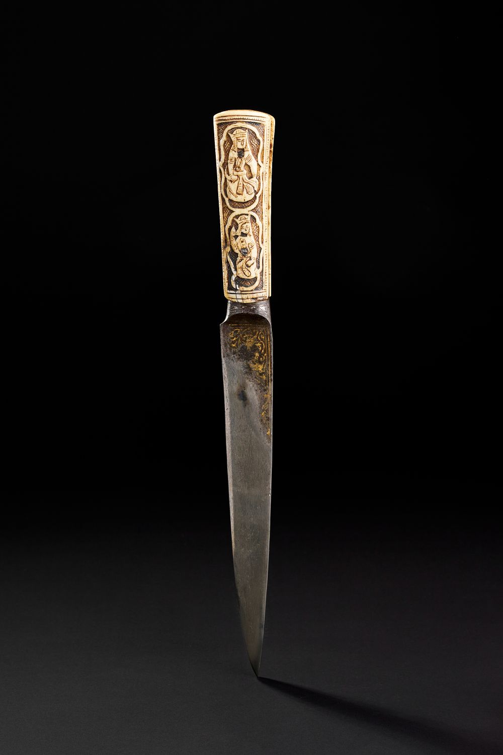 Lot 185: AN EARLY 19TH CENTURY QAJAR BONE HILTED DAGGER WITH SILVER AND GOLD INALID WATERED STEEL BLADE