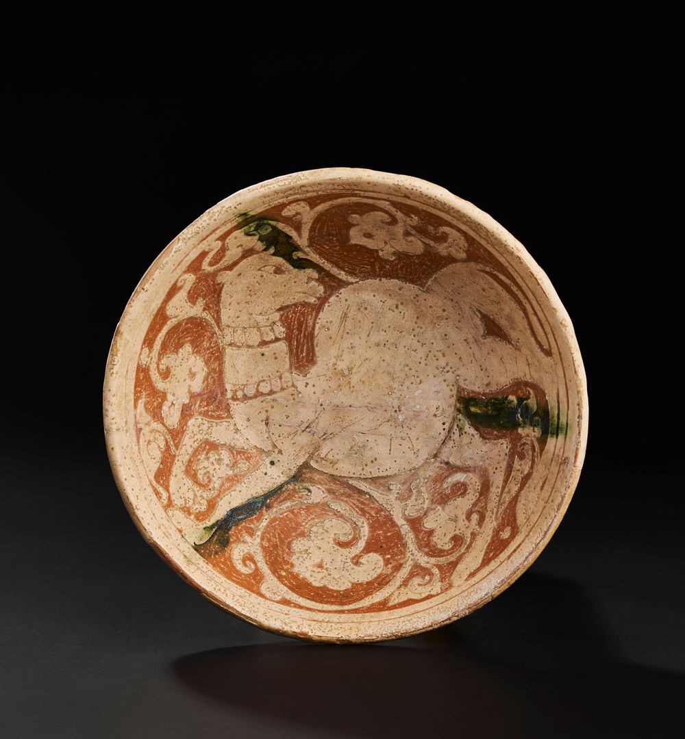 Lot 198: A PERSIAN SELJUK GARUS WARE POTTERY BOWL DEPICTING A CAMEL, POSSIBLY 12TH CENTURY