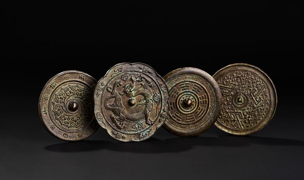 Lot 257: A GROUP OF FOUR EARLY CHINESE BRONZE MIRRORS