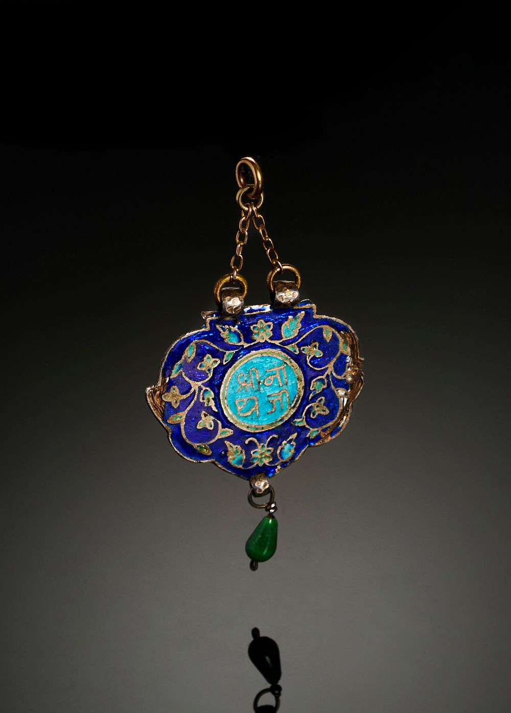Lot 315: AN INSCRIBED INDIAN ENAMELLED SILVER PENDENT, 19TH CENTURY