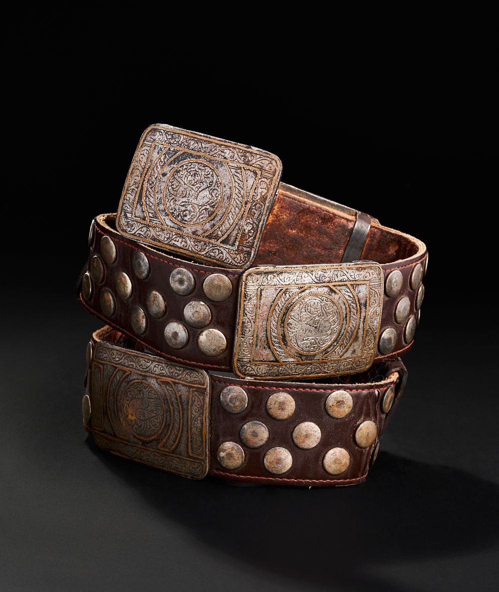 Lot 267: A LEATHER BELT WITH BRONZE AND METAL MOUNTS PROBABLY SELJUK OR OTTOMAN