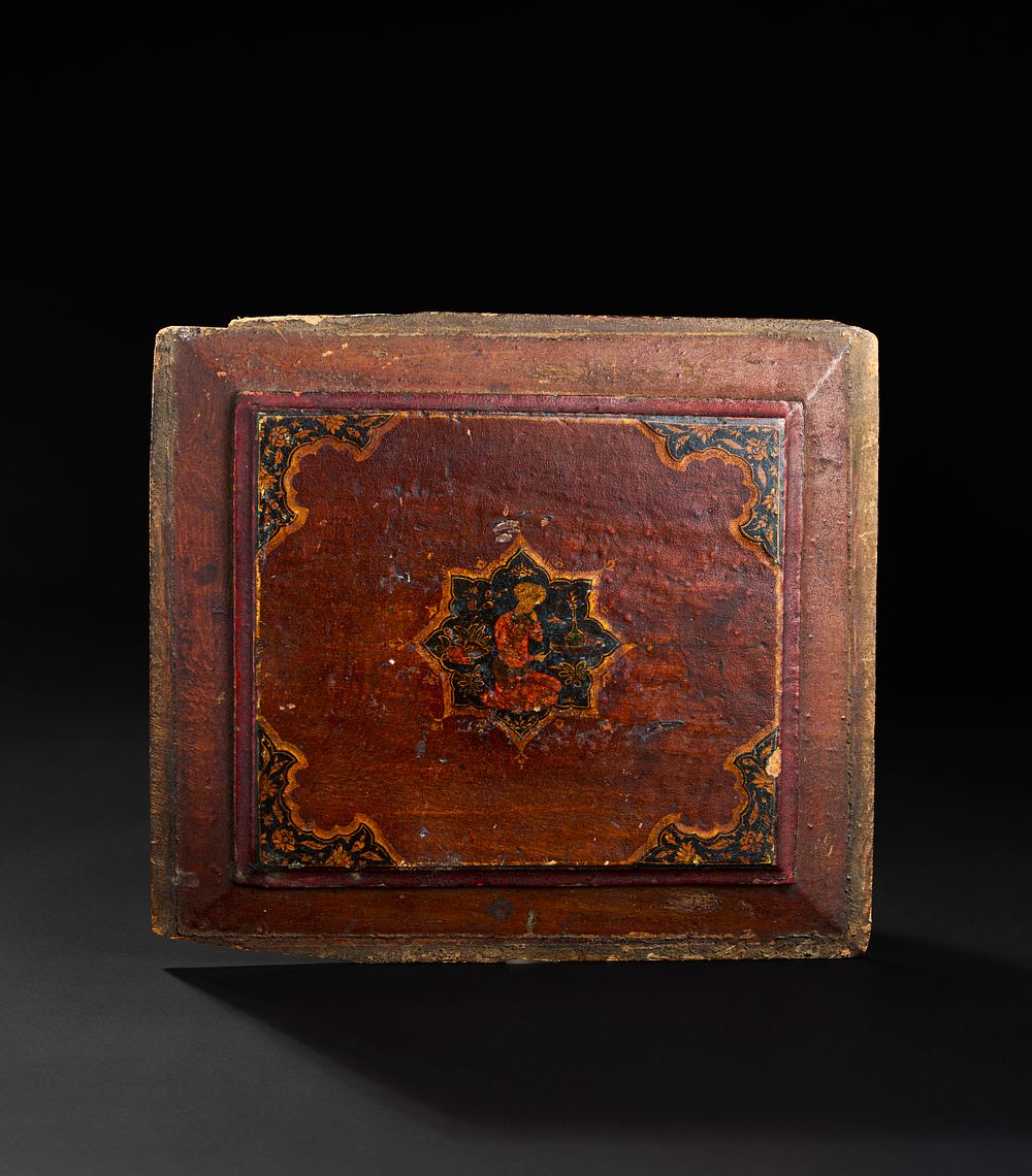 Lot 298: A SAFAVID PAINTED WOODEN PANEL DEPICTING A SEATED FIGURE, 17TH CENTURY